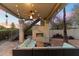 Covered patio with seating area, fireplace and string lights at 24218 N 85Th St, Scottsdale, AZ 85255