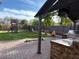 Outdoor patio with grill and view of backyard play area at 2507 W Maldonado Rd, Phoenix, AZ 85041