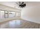 Bright living room featuring wood-look tile floors and large windows at 3059 E Hazeltine Way, Chandler, AZ 85249