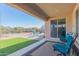 Spacious backyard with a covered patio, artificial turf, and seating area at 33115 N 25Th Dr, Phoenix, AZ 85085