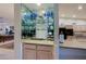 Built-in wet bar with mirrored shelving and glass storage at 3417 N Snead Dr, Goodyear, AZ 85395