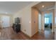 Bright hallway with hardwood floors, leading to bedrooms at 40160 W Mary Lou Dr, Maricopa, AZ 85138