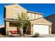 Two-story house with beige exterior, white garage door, and landscaping at 4488 W Charlie Dr, San Tan Valley, AZ 85144