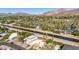 Aerial view of a house near a canal, with mountains in the background at 4620 E Montecito Ave, Phoenix, AZ 85018