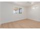 Bright bedroom featuring hardwood floors and plantation shutters at 4620 E Montecito Ave, Phoenix, AZ 85018