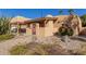 Tan stucco house with a covered entryway and drought-tolerant landscaping at 4620 E Montecito Ave, Phoenix, AZ 85018