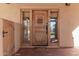 Elegant rustic wood front door with a metal accent and sidelights at 4620 E Montecito Ave, Phoenix, AZ 85018