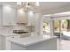 Updated kitchen with gas range, white cabinets, and access to backyard at 4620 E Montecito Ave, Phoenix, AZ 85018