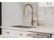 Kitchen sink and faucet with gold finish and white cabinets at 4620 E Montecito Ave, Phoenix, AZ 85018
