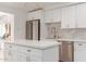 Modern kitchen with white cabinets, gold fixtures, and quartz countertops at 4620 E Montecito Ave, Phoenix, AZ 85018