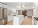 Open concept kitchen with island, white cabinets, and stainless steel appliances at 4620 E Montecito Ave, Phoenix, AZ 85018
