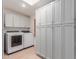 Laundry room with white cabinets and washer and dryer included at 4620 E Montecito Ave, Phoenix, AZ 85018