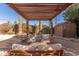 Pergola patio with seating area and shed in the background at 4620 E Montecito Ave, Phoenix, AZ 85018