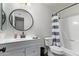 Clean bathroom with white vanity and striped shower curtain at 540 N May St # 1102, Mesa, AZ 85201