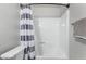 Simple bathroom with white tub and gray shower curtain at 540 N May St # 1102, Mesa, AZ 85201