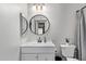 Bathroom with vanity, toilet and round mirror at 540 N May St # 1102, Mesa, AZ 85201