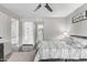 Bedroom with ceiling fan, wood frame bed, and bathroom access at 540 N May St # 1102, Mesa, AZ 85201