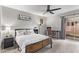 Spacious bedroom with ceiling fan, and wood bed frame at 540 N May St # 1102, Mesa, AZ 85201
