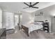 Bedroom with ceiling fan, wood bed frame, and access to bathroom at 540 N May St # 1102, Mesa, AZ 85201
