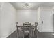 Simple dining area with four chairs and a light-colored wall at 540 N May St # 1102, Mesa, AZ 85201