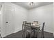 Small dining area with four chairs and dark flooring at 540 N May St # 1102, Mesa, AZ 85201