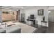 Open living area with sectional sofa, flat-screen TV, and backyard access at 540 N May St # 1102, Mesa, AZ 85201