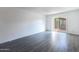 Living room with gray floors and sliding door to patio at 5671 N 79Th St # 2, Scottsdale, AZ 85250