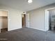 Bright bedroom with neutral walls and carpet, and access to bathroom at 5932 W Garfield St, Phoenix, AZ 85043