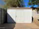 White storage shed with X-design on the door at 5932 W Garfield St, Phoenix, AZ 85043