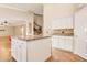 Kitchen with white cabinets, granite countertops, and large island at 6901 E Evans Dr, Scottsdale, AZ 85254