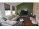 Spacious living room with a sectional sofa and large TV at 7229 S 48Th Ln, Laveen, AZ 85339