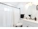 Clean bathroom with shower/tub combo, white vanity, and a round mirror at 7272 E Gainey Ranch Rd # 75, Scottsdale, AZ 85258