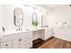 Bathroom with double vanity, modern mirrors, and wood floors at 7272 E Gainey Ranch Rd # 75, Scottsdale, AZ 85258
