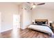 Main bedroom with high ceiling, ensuite bathroom access, and wood floors at 7272 E Gainey Ranch Rd # 75, Scottsdale, AZ 85258