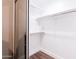 Large walk-in closet with custom shelving and hanging rods at 7272 E Gainey Ranch Rd # 75, Scottsdale, AZ 85258