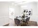 Elegant dining room with glass table, velvet chairs, and kitchen access at 7272 E Gainey Ranch Rd # 75, Scottsdale, AZ 85258