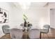 Bright dining area with a glass table, chandelier, and modern decor at 7272 E Gainey Ranch Rd # 75, Scottsdale, AZ 85258