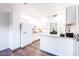Updated kitchen with white cabinets, island, and hardwood floors at 7272 E Gainey Ranch Rd # 75, Scottsdale, AZ 85258
