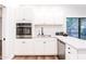 Well-equipped kitchen with white cabinets, stainless steel appliances, and granite counters at 7272 E Gainey Ranch Rd # 75, Scottsdale, AZ 85258