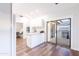 Open concept kitchen with island, slider to patio, and hardwood floors at 7272 E Gainey Ranch Rd # 75, Scottsdale, AZ 85258