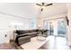 Spacious living area with hardwood floors, sectional sofa, and large window at 7272 E Gainey Ranch Rd # 75, Scottsdale, AZ 85258