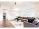 Open living room with hardwood floors, sectional sofa, and access to office at 7272 E Gainey Ranch Rd # 75, Scottsdale, AZ 85258