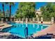 Inviting community pool with surrounding lounge chairs at 7272 E Gainey Ranch Rd # 75, Scottsdale, AZ 85258