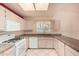 L-shaped kitchen with white cabinets and granite counters at 9047 W Lisbon Ln, Peoria, AZ 85381