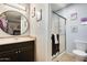 Bathroom with a large vanity, shower, and decorative accents at 10827 N 65Th Ave, Glendale, AZ 85304