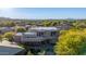 Aerial view of a large house with a flat roof, pool, and mountain views at 10906 E Southwind Ln, Scottsdale, AZ 85262