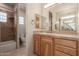 Double vanity bathroom with tiled shower and separate toilet area at 10906 E Southwind Ln, Scottsdale, AZ 85262