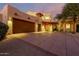 Stucco home with double garage doors and desert landscaping at 10906 E Southwind Ln, Scottsdale, AZ 85262