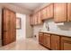 Laundry room with wood cabinets and access to backyard at 10906 E Southwind Ln, Scottsdale, AZ 85262