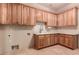 Laundry room with wood cabinets and a large countertop at 10906 E Southwind Ln, Scottsdale, AZ 85262